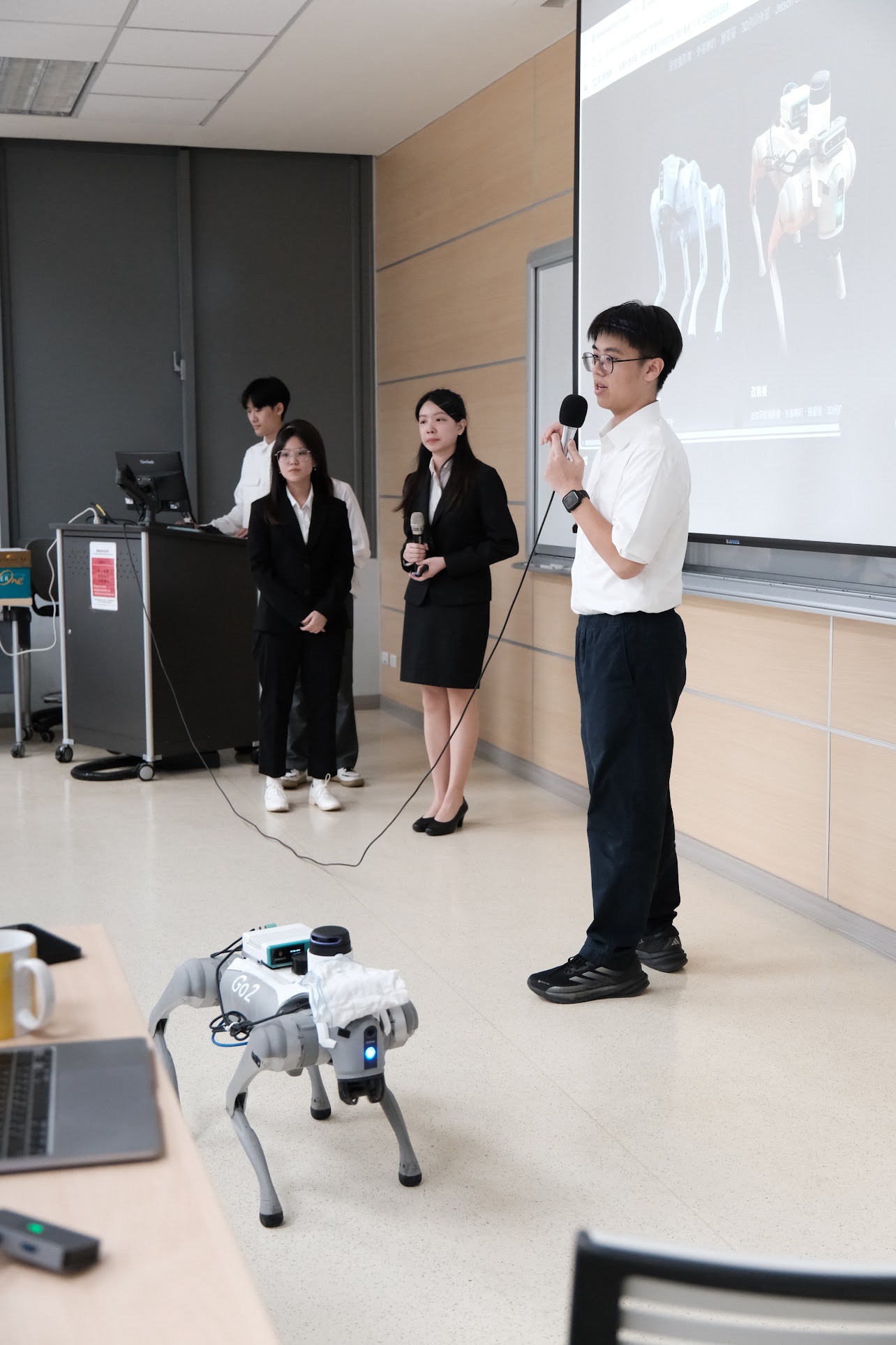 Presenting the PawAI robot dog on stage with my team