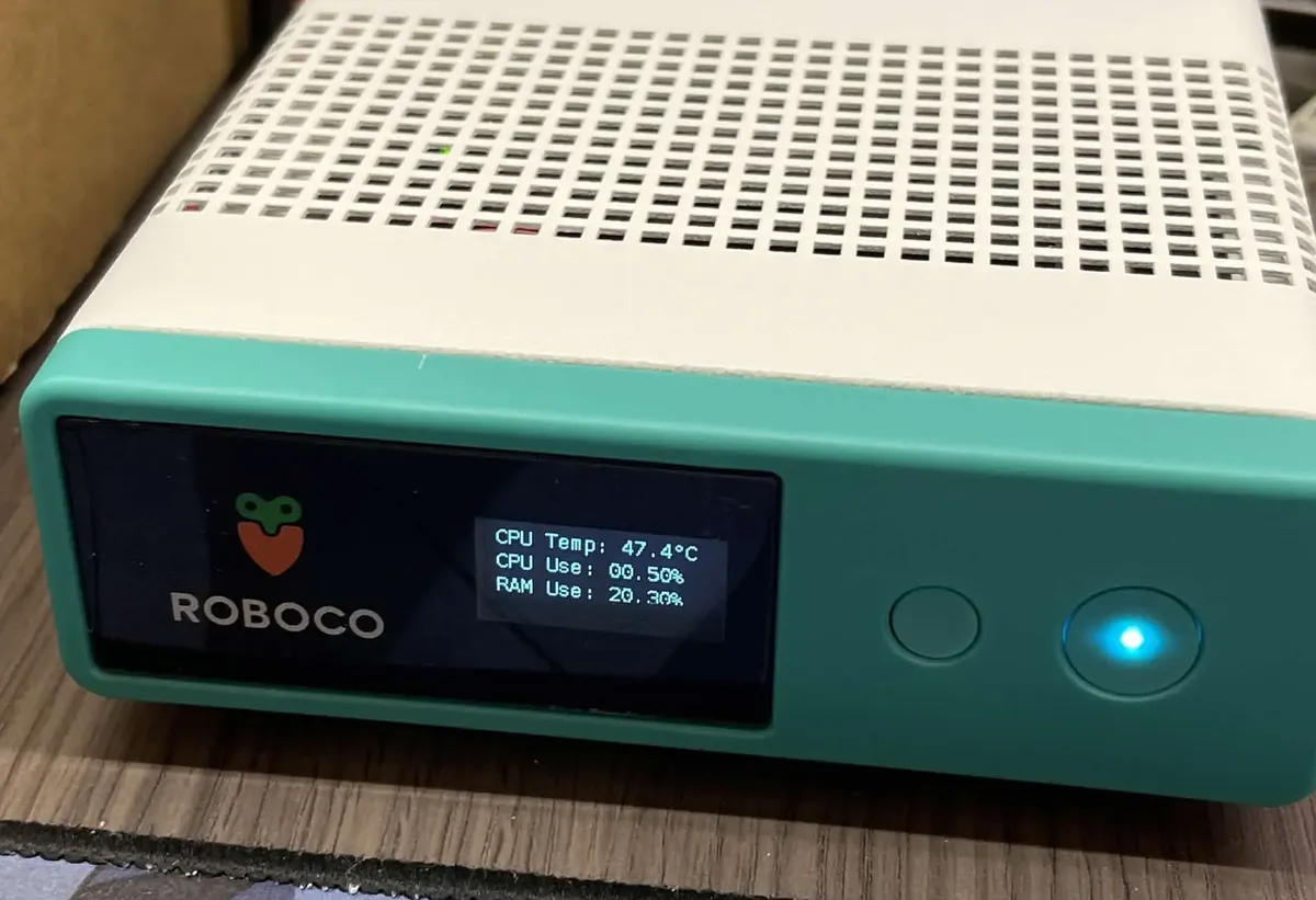 Photo: the white-and-green Jetson Orin Nano box, its small screen showing CPU temperature 47.4 °C, CPU usage and memory usage