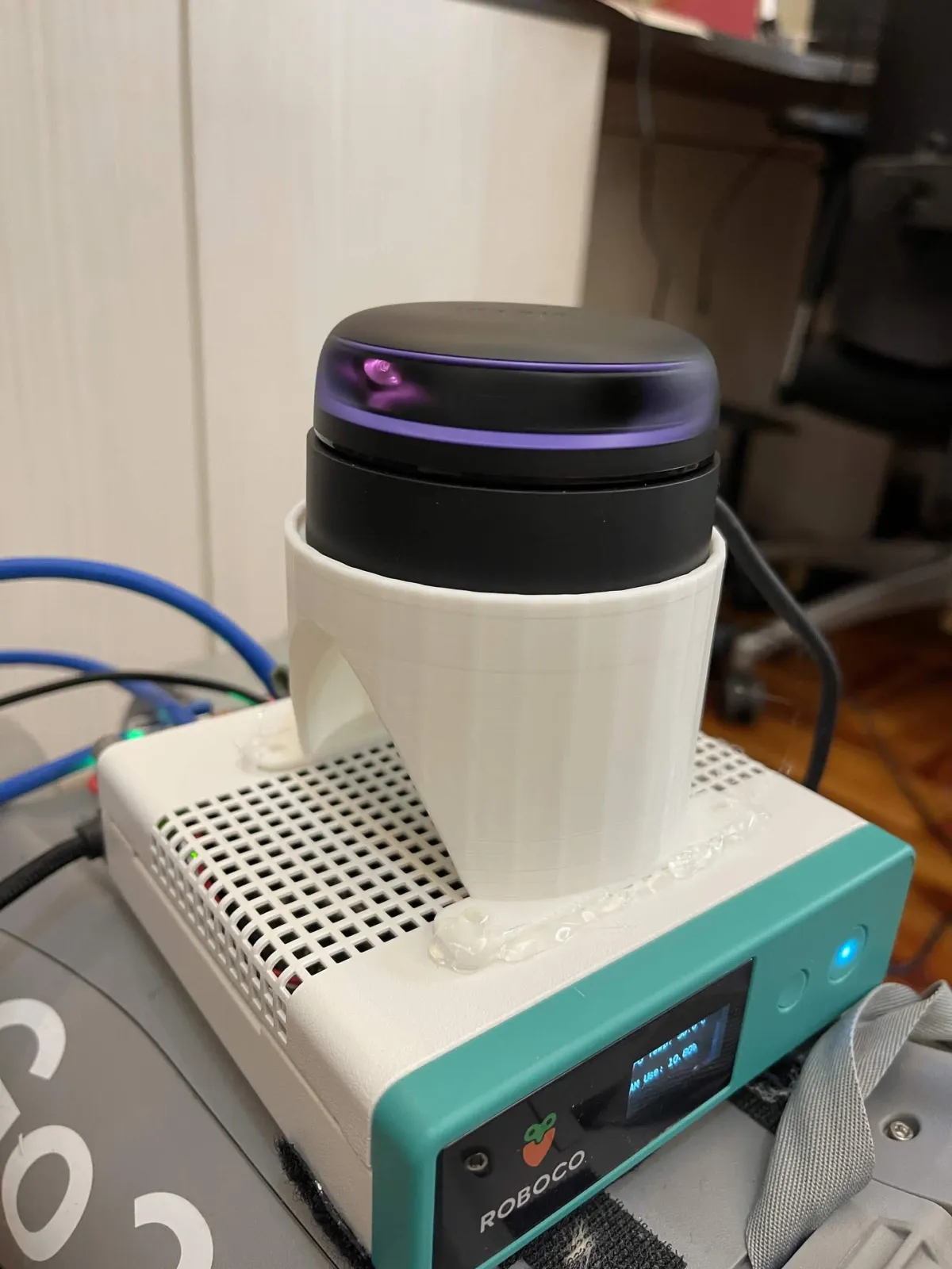 The lidar fixed on a white 3D-printed mount above the white-and-green compute box