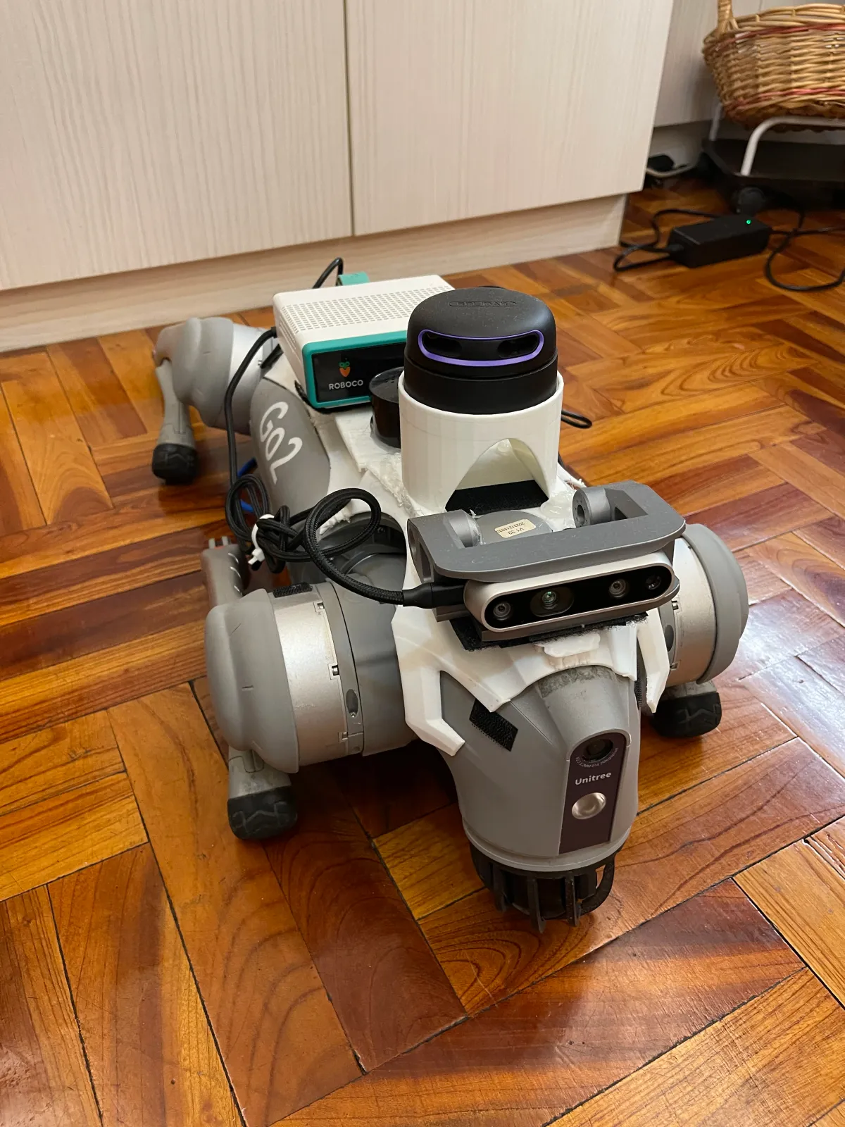 Top view of PawAI: the depth camera on the forehead, the lidar, the white compute box and cables