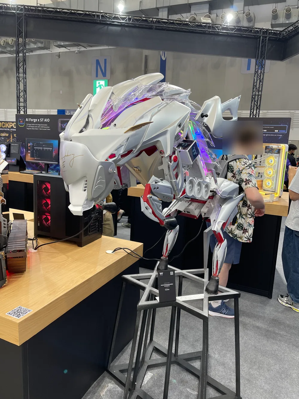 A white mechanical-dragon display piece next to a gaming PC