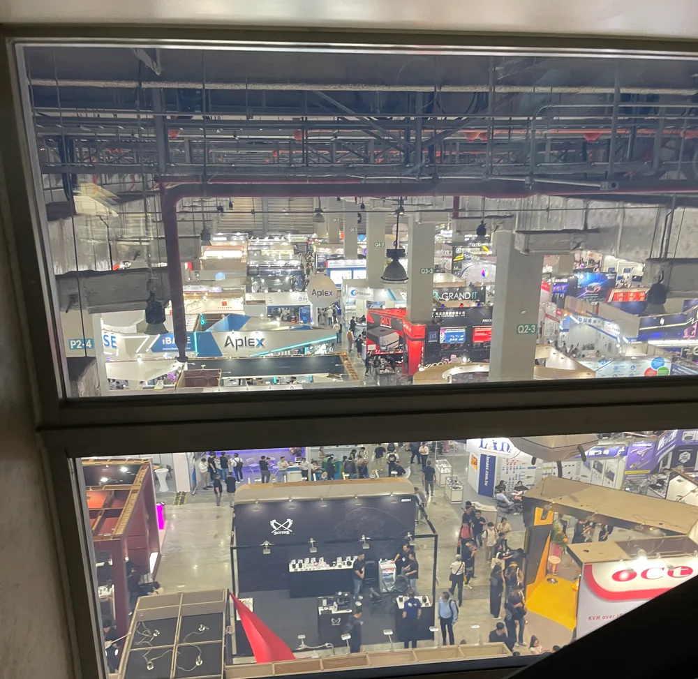 Looking down from an upstairs window at Nangang Exhibition Center, the whole floor packed with booths and crowds