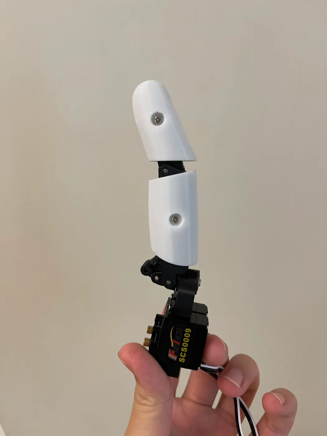 Holding one assembled finger with an SCS0009 servo at its base