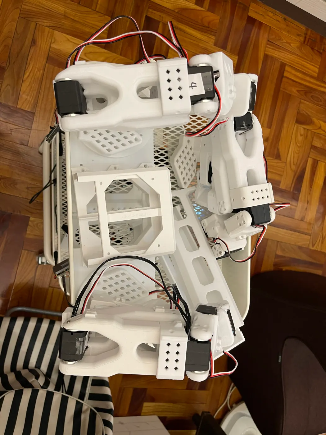 Top-down view of the cart's top shelf: two arms and a white 3D-printed neck mount