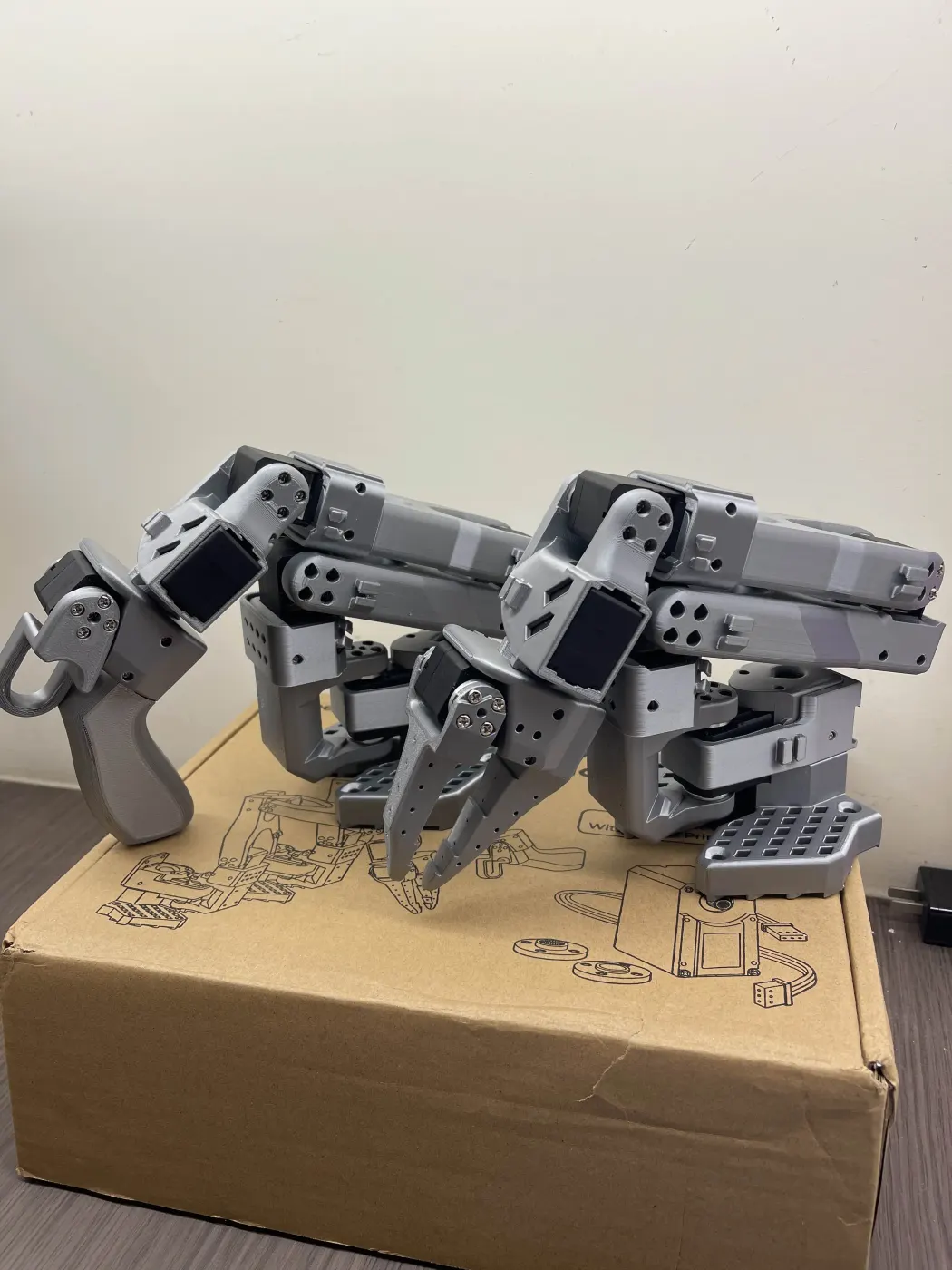 The first leader and follower arms sitting on a cardboard box