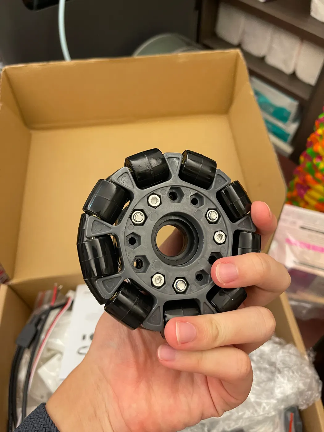 Holding a black omnidirectional wheel