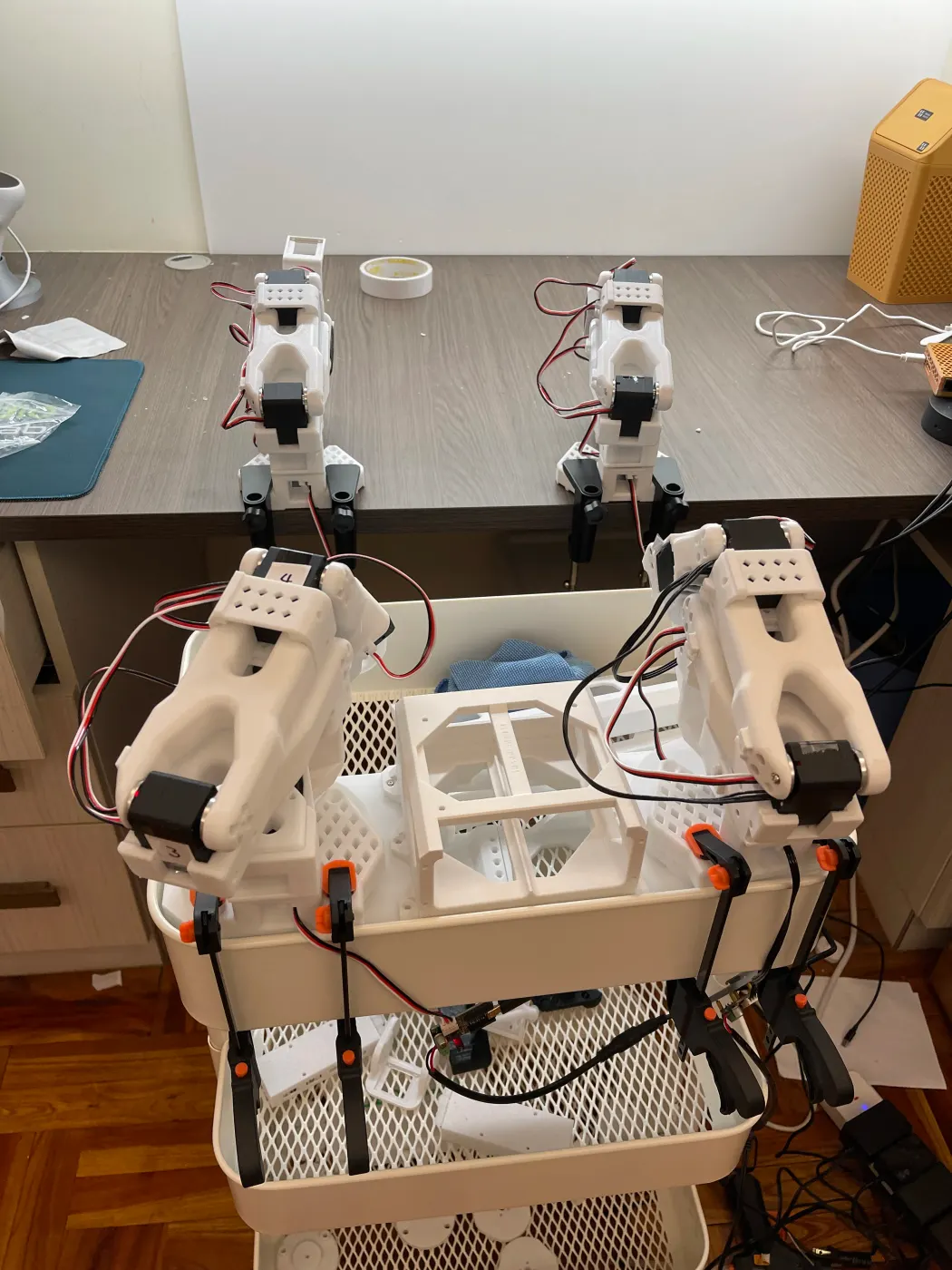 Front view: two arms on the desk and two more on a cart